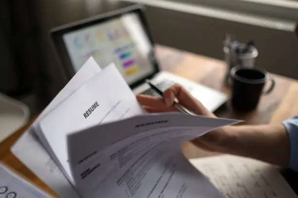 Photo of Applying for a job, filing a resume Experience, candidates stand the document with the company hr to get elected to work.