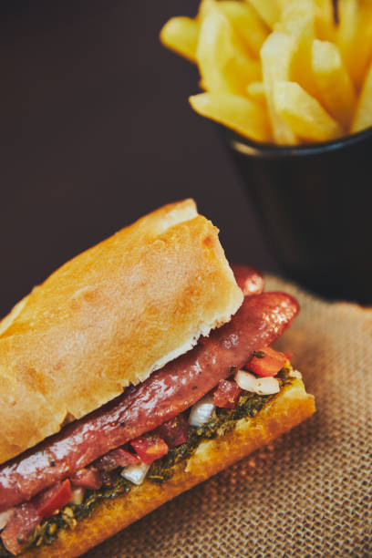 istock Argentinian choripan with chimichurri and creole sauce. 1318927285