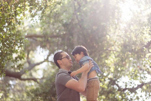 istock Dad Lifting Son in the Air 1318928162