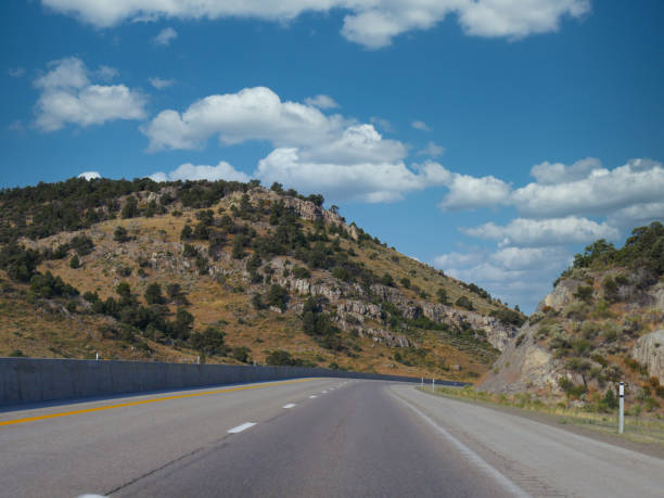 istock Winding paved road in between hills long Highway 80 in Nevada. 1318928927