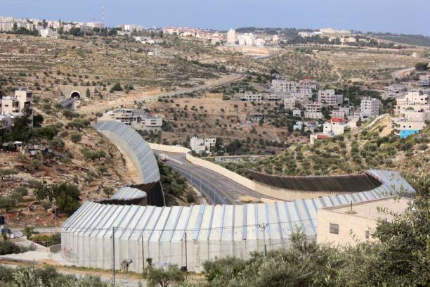 Wall Separating Palestine (West Bank) and Israel Elevated view of tall concrete wall that physically separates Palestinian territory (West Bank) and Israel - Bethlehem, Palestine bethlehem west bank stock pictures, royalty-free photos & images
