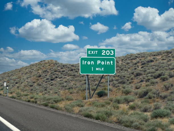 istock Roadside sign at Interstate 80 with distance and direction to Iron Point. 1318930013