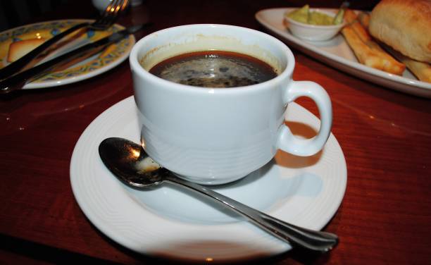 istock Cup of coffee, with breads in separate plates 1318933045