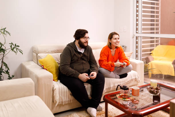 istock Couple playing video game together 1318934197