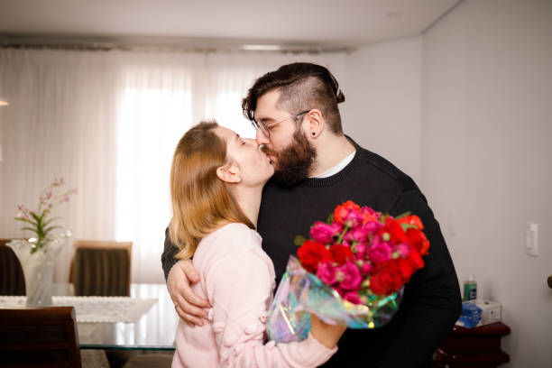 Couple Kissing With Flowers Stock Photo - Download Image Now - 25