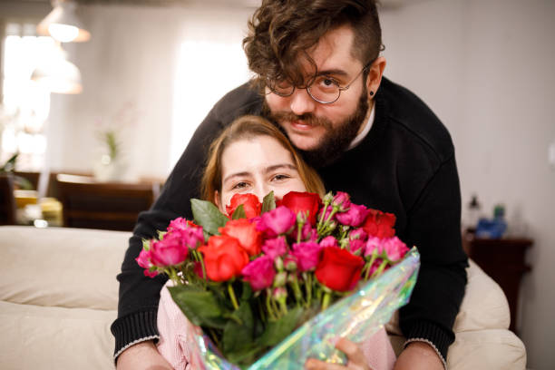 istock Young couple with flowers 1318934282