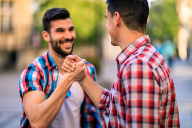 istock Two man friends shaking hands 1318934410