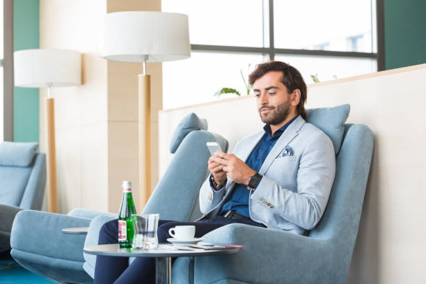 istock Businessman using smart phone at airport 1318936172