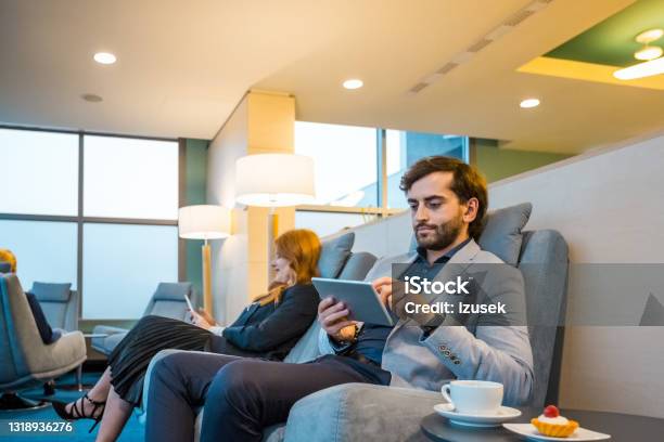 Businessman Using Digital Tablet At Airport Lounge Stock Photo - Download Image Now - Airport, High Society, 35-39 Years
