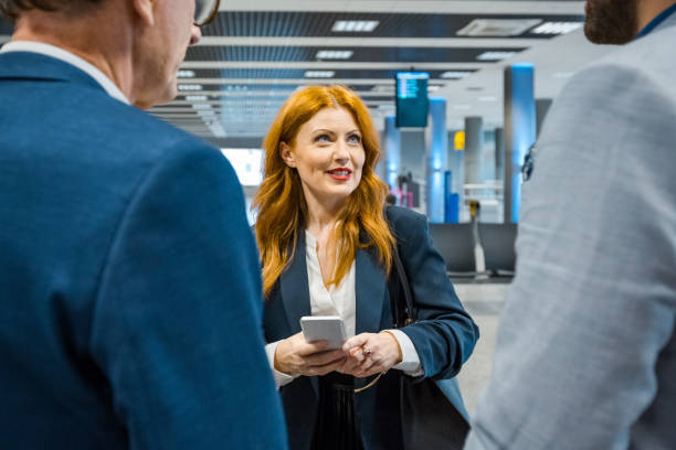istock Business colleagues discussing at airport terminal 1318937793