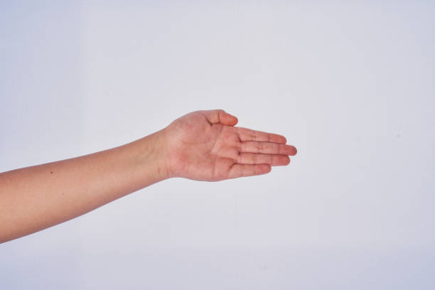 Male hand holding a white plastic fork isolated on white background with clipping path.