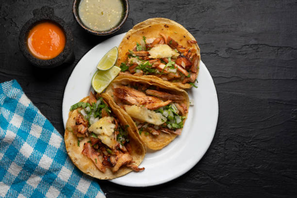 istock Pork tacos called al pastor with pineapple on dark background. Mexican tacos 1318944419