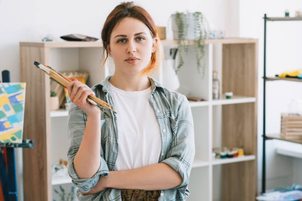 istock art class painting confident female artist studio 1318947943