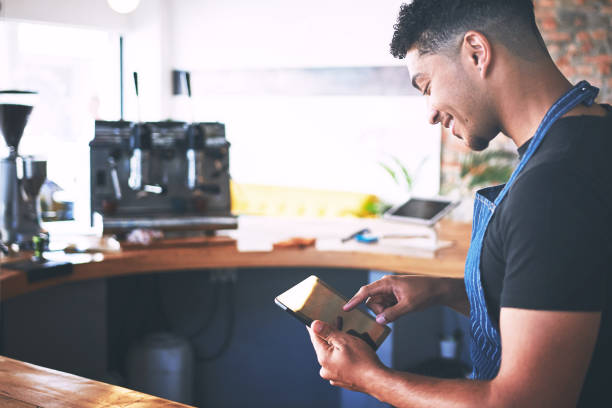 istock Shot of a confident young man using a digital tablet while working in a cafe 1318951618