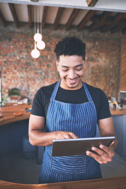 istock Shot of a confident young man using a digital tablet while working in a cafe 1318951623