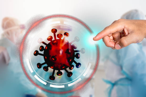 istock Right hand index finger Pointed through the corona virus cell armor and destroyed. Blur background of hospital operations The concept is to work together to eliminate the coronavirus. 1318953517