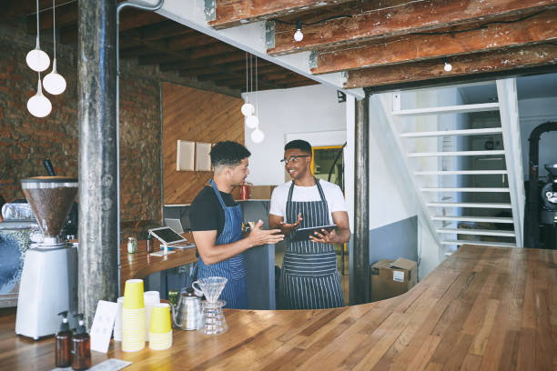 istock Shot of two young men using a digital tablet while working in a cafe 1318954398