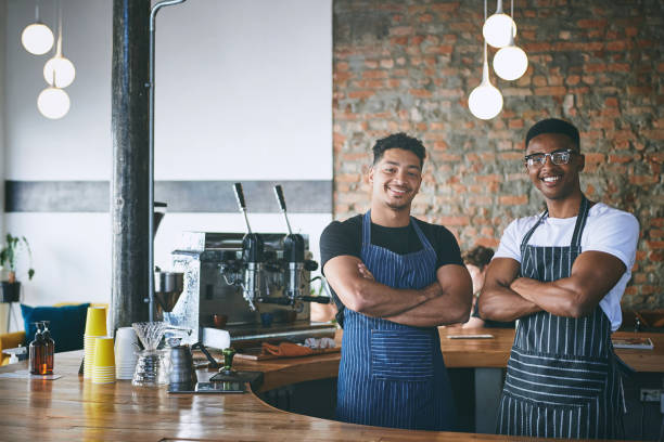 istock Shot of two confident young men working in a cafe 1318954406
