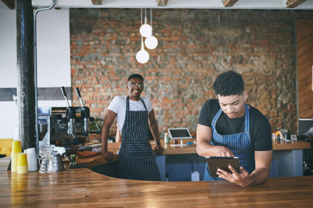 istock Shot of two young men using a digital tablet while working in a cafe 1318954411