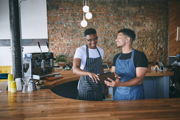 istock Shot of two young men using a digital tablet while working in a cafe 1318954413