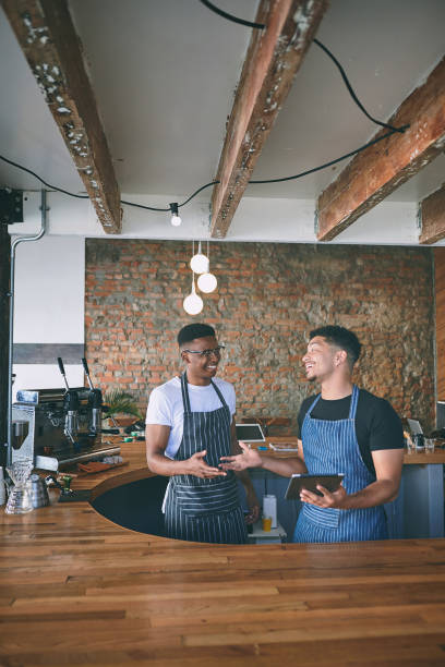 istock Shot of two young men using a digital tablet while working in a cafe 1318954414