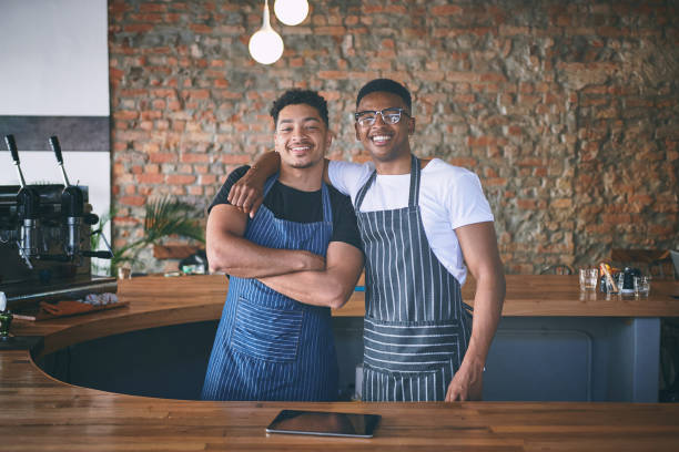 istock Shot of two confident young men working in a cafe 1318954421