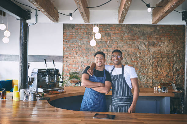 istock Shot of two confident young men working in a cafe 1318954422