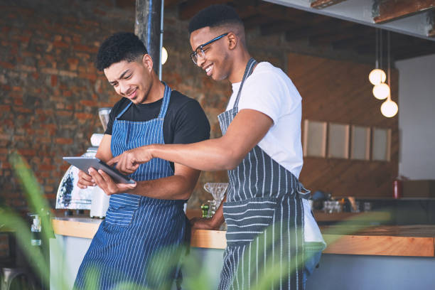 istock Shot of two young men using a digital tablet while working in a cafe 1318954428