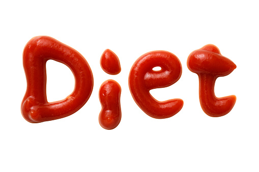 Diet letters written made with ketchup, isolated on white with clipping path.