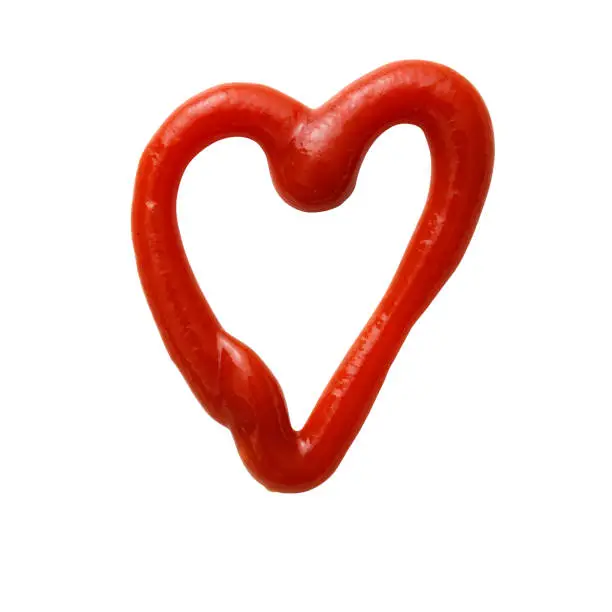 Photo of Isolated shot of heart-shaped ketchup made with ketchup on a white background