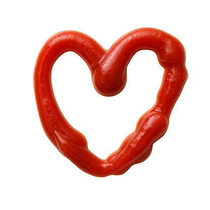 Heart-shaped ketchup made with ketchup, isolated on white with clipping path.