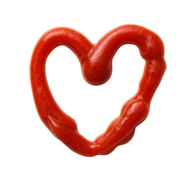 Photo of Isolated shot of heart-shaped ketchup made with ketchup on a white background