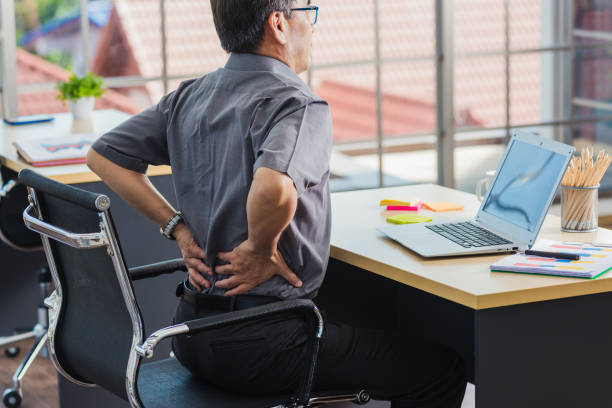 istock senior businessman working with laptop computer has a problem with back pain 1318956037