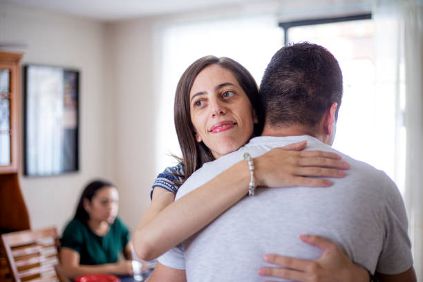 istock Man hugging woman at home 1318956255