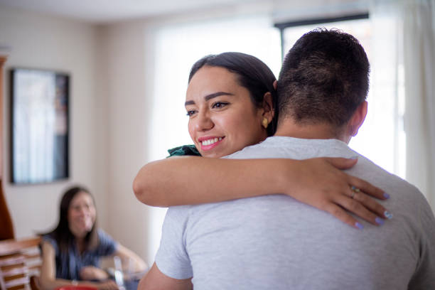 istock Man hugging woman at home 1318956294