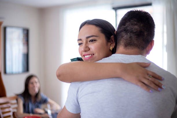 istock Man hugging woman at home 1318956305