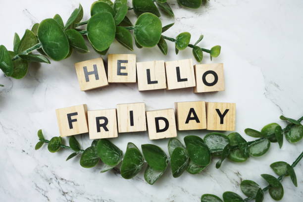 istock Hello Friday alphabet letter with green leave flat lay on marble background 1318959615
