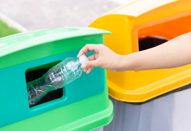 istock Close up hand holding garbage plastic bottle into recycle trash bin, selective focus 1318964084