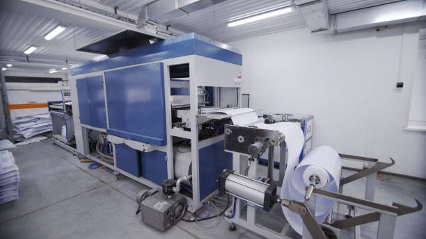 istock Machines create packing for bottles. Process of manufacturing plastic containers on extrusion equipment-moving mold. Work on high performance and precision machinery 1318964213