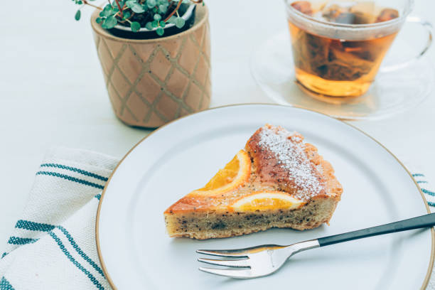 istock Tea and orange tart cake for afternoon break. 1318966113