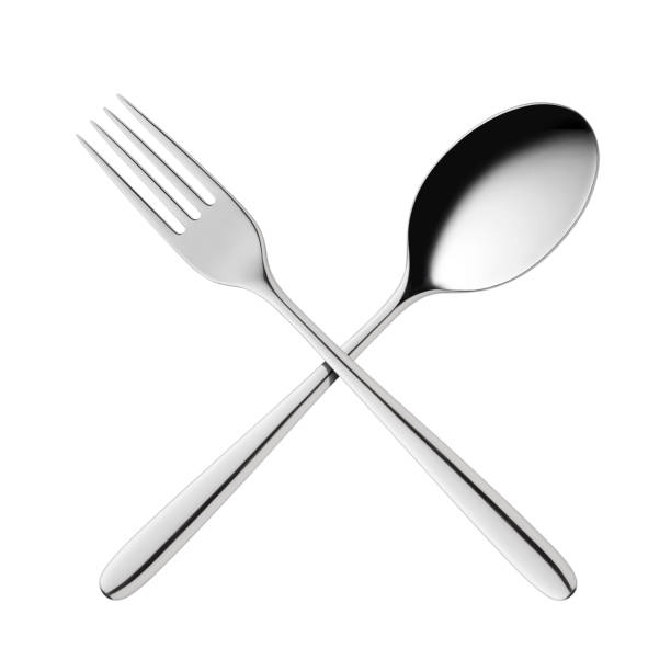 Crossed fork and spoon Fork and spoon isolated on white background. serving utensil stock pictures, royalty-free photos & images