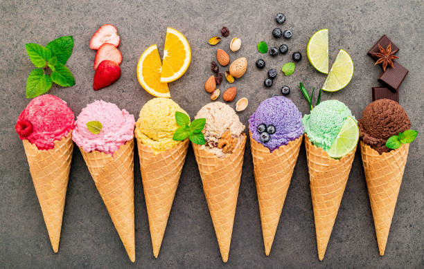istock Flat lay ice cream cones collection on dark stone background . Blank crispy ice cream cone with copy space for sweets menu design. 1318971874