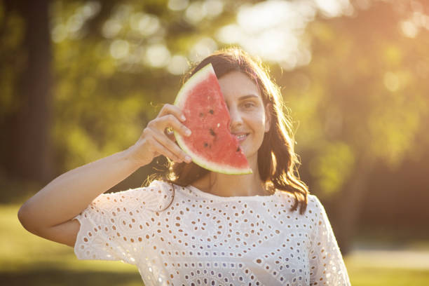 istock Woman holding watermelon. 1318973934