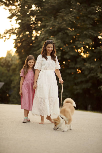 istock Time for walk. Mom, kid and dog in nature. 1318974669