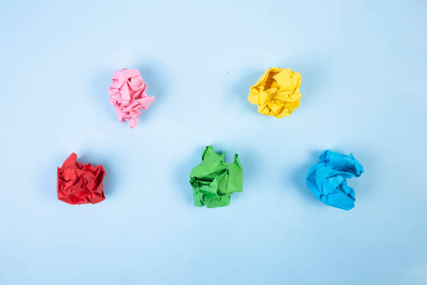 istock Color paper balls on blue background 1318975952
