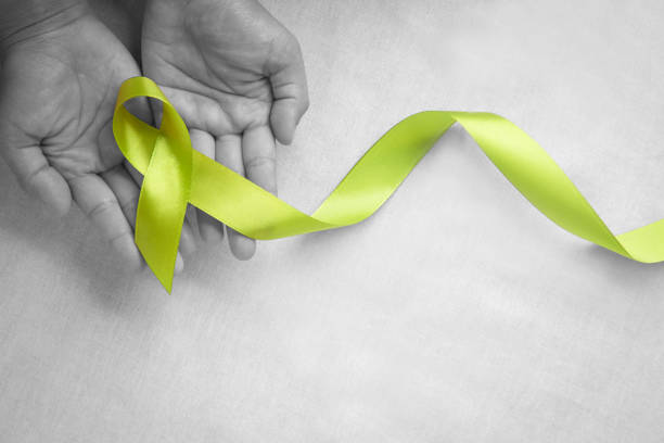istock Hands holding light lime green ribbon on white fabric background with copy space. World Mental Health Day and Lymphoma Awareness symbol. Healthcare medical and insurance concept. 1318975972