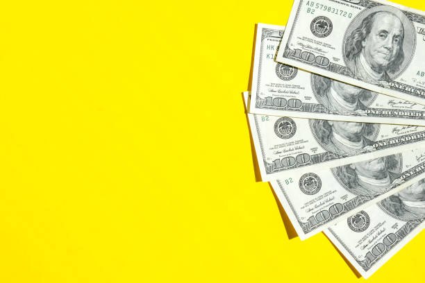 istock Us dollar bills in creative layout. Business concept, development perspective. Flat lay. Top view. Minimal creative style pattern. Copy space. Yellow background 1318976804
