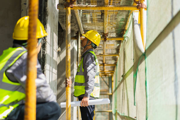 istock The construction project with the drawings in hand is to check the construction situation under the scaffolding 1318976928