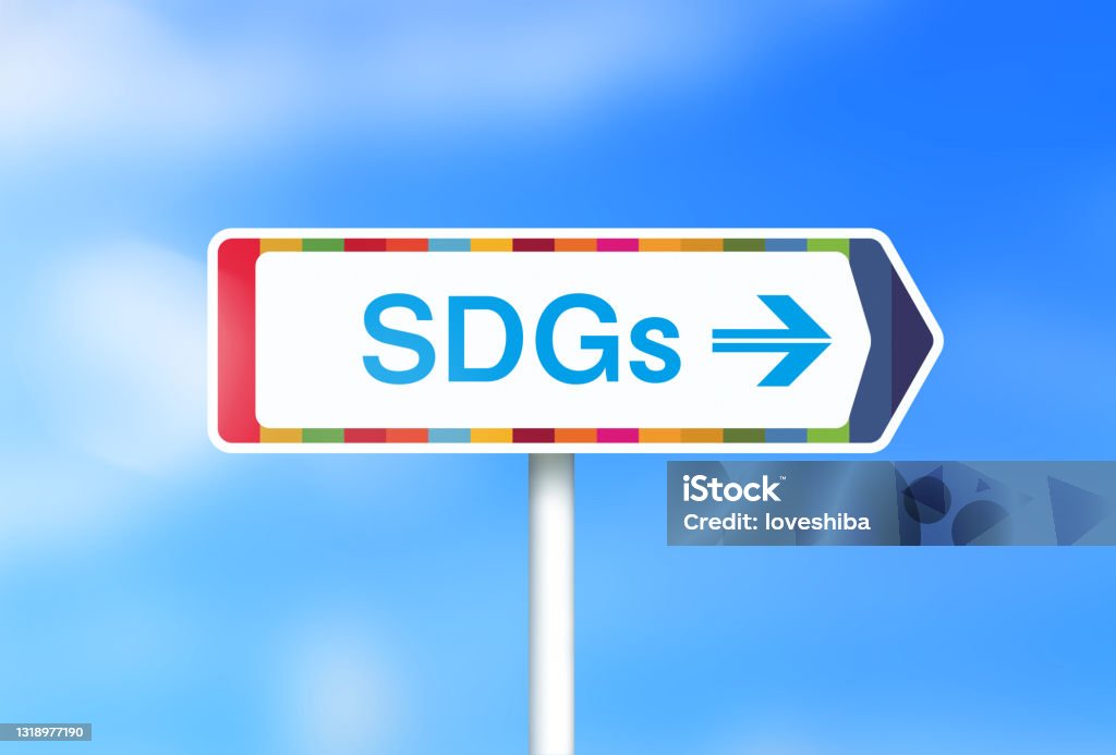 Image of a sign saying "SDGs" with a background of fresh greenery and clouds Photographed in Japan. Sustainable Development Goals Stock Photo