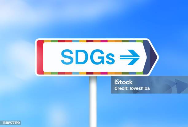 Image Of A Sign Saying Sdgs With A Background Of Fresh Greenery And Clouds Stock Photo - Download Image Now
